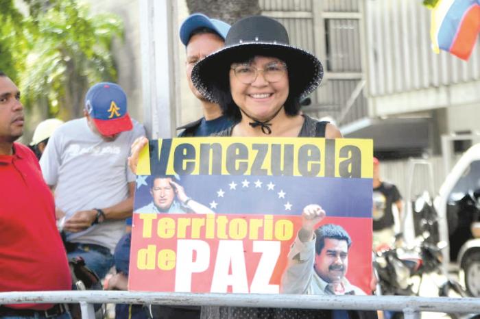 Venezolana con un cartel «Venezuela, territoro de paz».