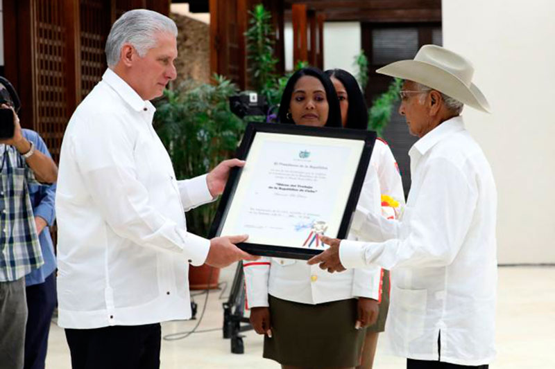Presidente cubano condecora a campesinos destacados.