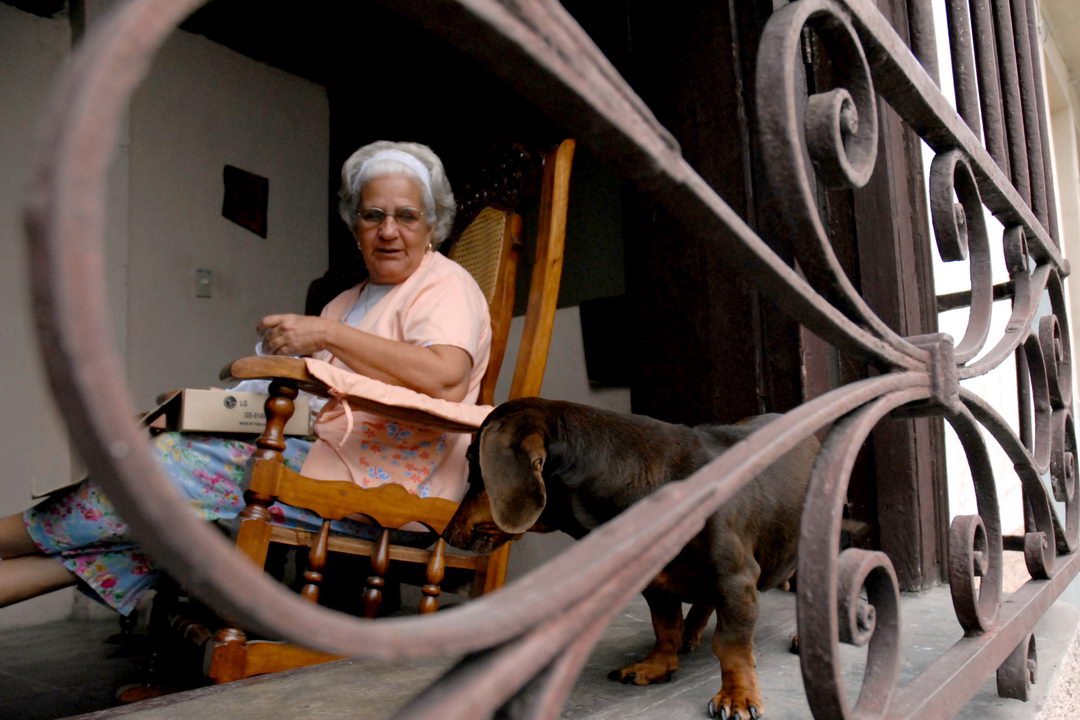 Anciana en casa con su perro.